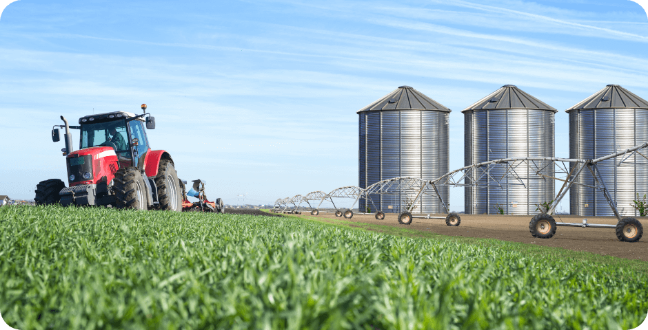 agriculture food production concept with tractor machine silos irrigation system