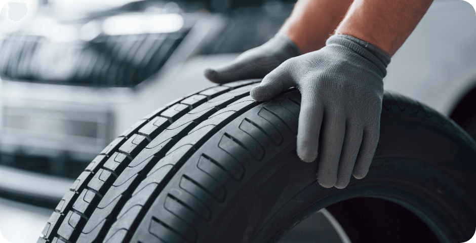 hands-only-mechanic-holding-tire-repair-garage-replacement-winter-summer-tires