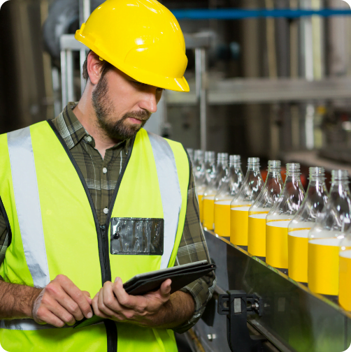 Factory worker reviewing the line