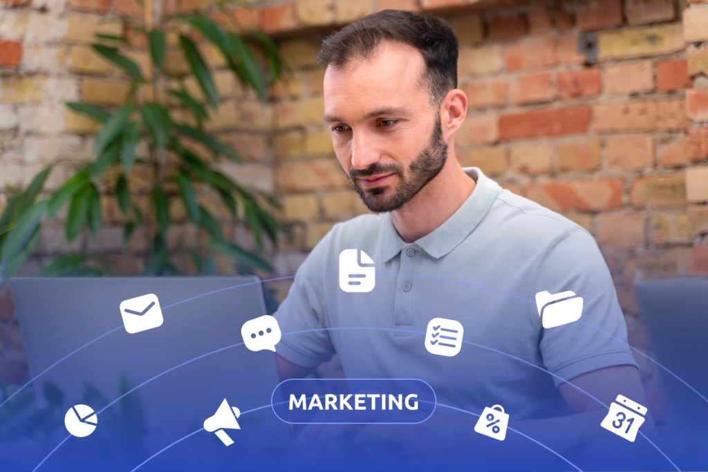 male using laptop with marketing related icons overlayed and the word MARKETING