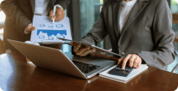 business-woman-manager-analyzing-datum-charts-typing-computer-making-notes-documents-table-office-business-team-conceptxa Accounting personnel
