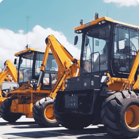 Yellow construction backhoes parked in a row for heavy equipment rental fleet management