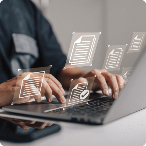 Person typing on a laptop with digital document icons floating, representing document management and organization