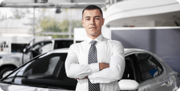 front-view-male-car-dealer-standing-with-arms-crossed front-view-male-car-dealer-standing-with-arms-crossed
