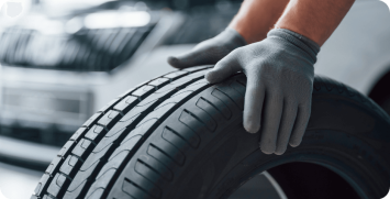 hands-only-mechanic-holding-tire-repair-garage-replacement-winter-summer-tires hands-only-mechanic-holding-tire-repair-garage-replacement-winter-summer-tires