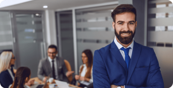 young-attractive-caucasian-smiling-satisfied-businessman-suit-standing-boardroom-with-arms-crossed-background-his-colleagues-having-meeting young-smiling-satisfied-businessman-suit-standing-boardroom-with-arms-crossed-background-his-colleagues-having-meeting